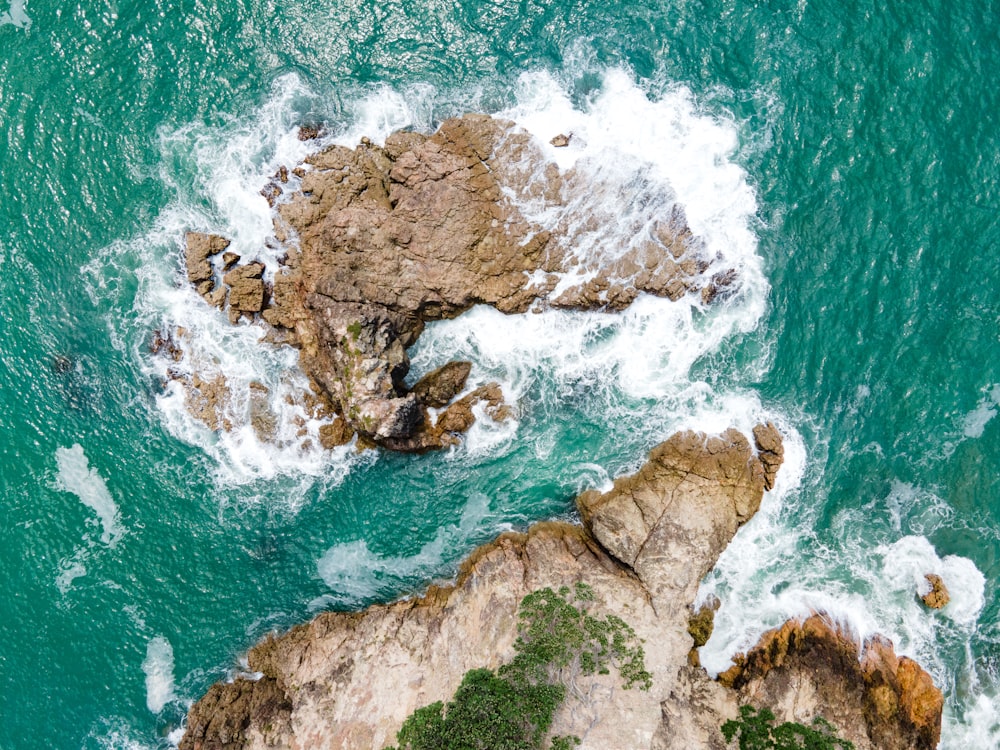 a bird's eye view of the ocean and rocks