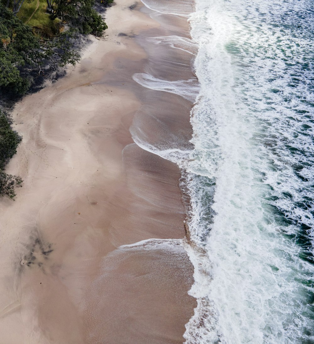 an aerial view of a sandy beach and ocean