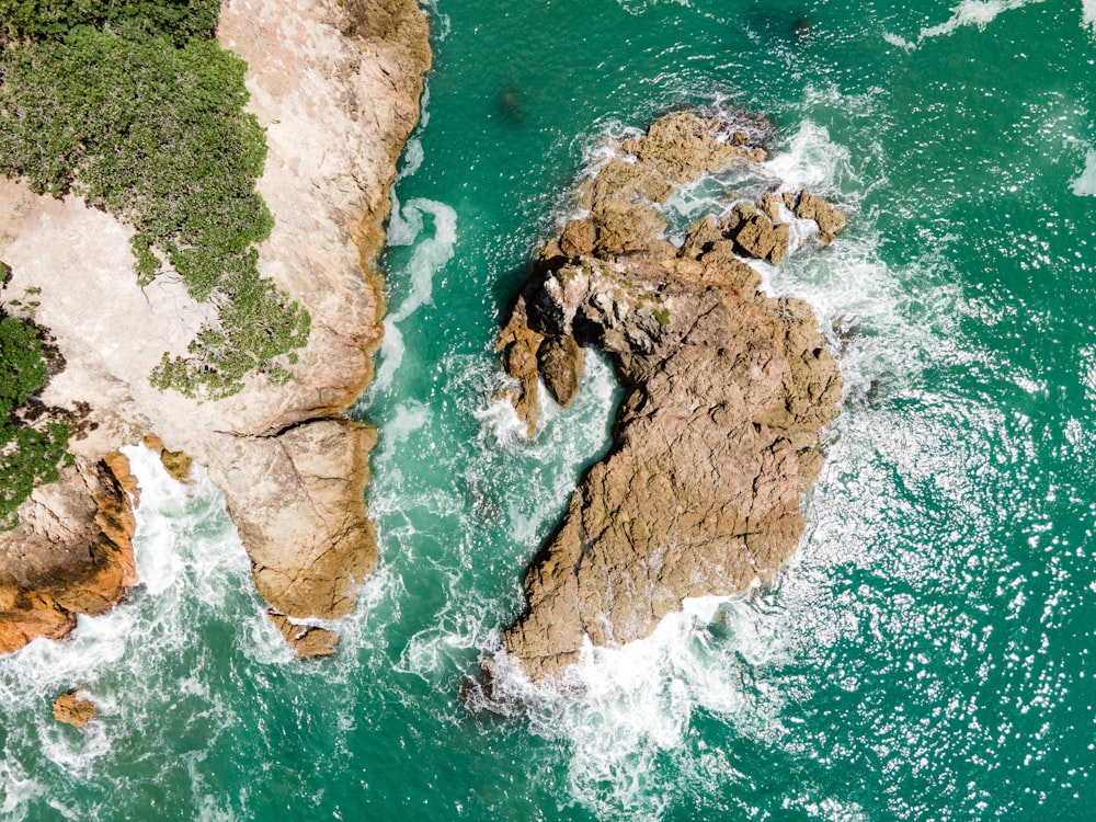 an aerial view of a rock formation in the ocean