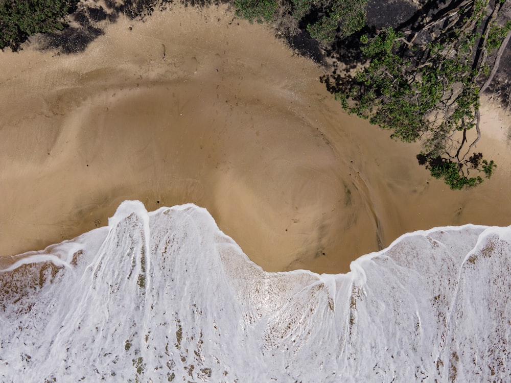 an aerial view of a sandy beach and ocean