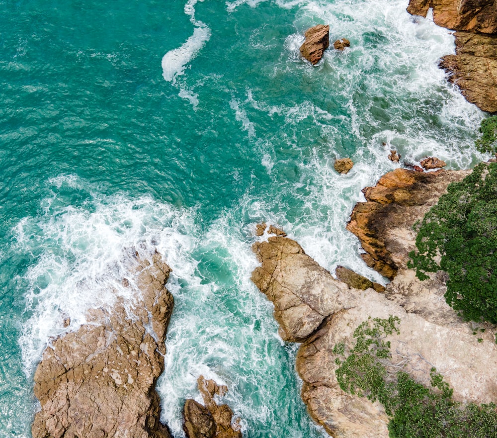 a bird's eye view of the ocean and rocks