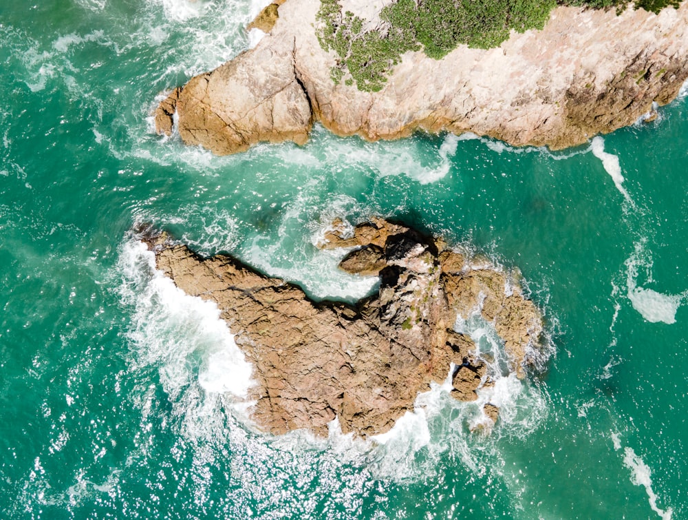 an aerial view of a rock formation in the ocean