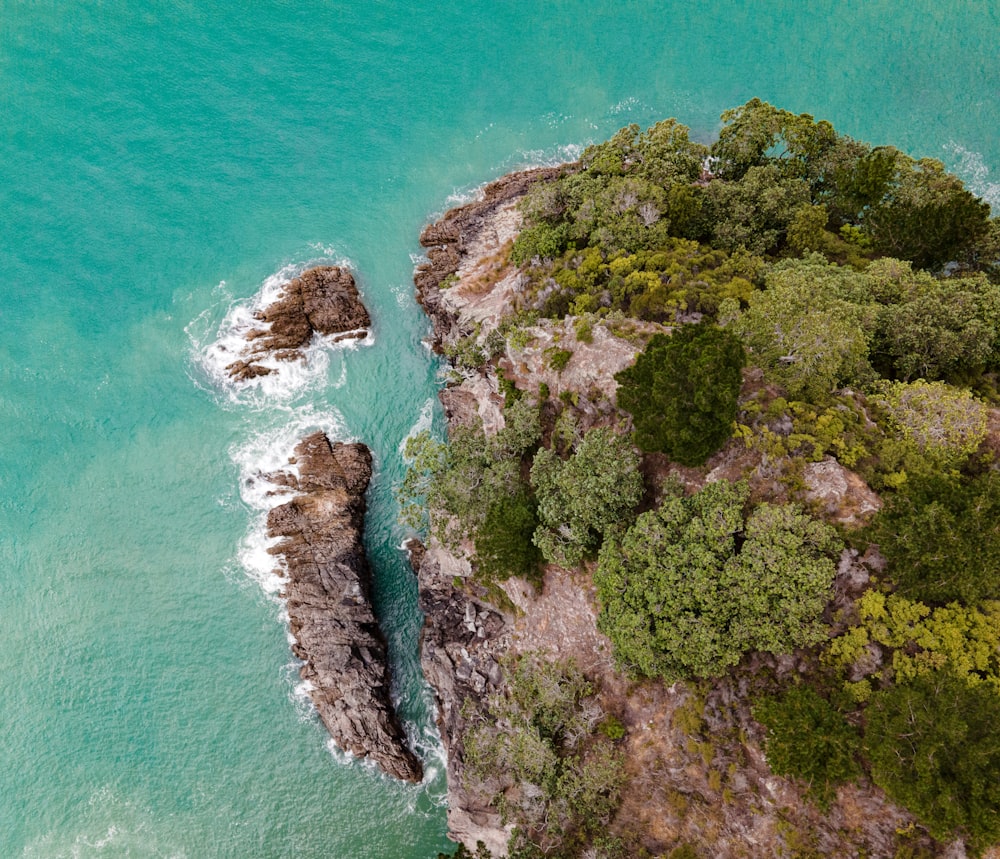 an aerial view of a rock formation in the ocean