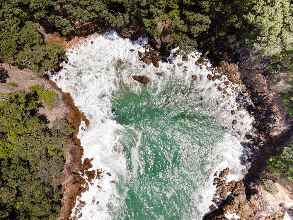 an aerial view of a body of water surrounded by trees