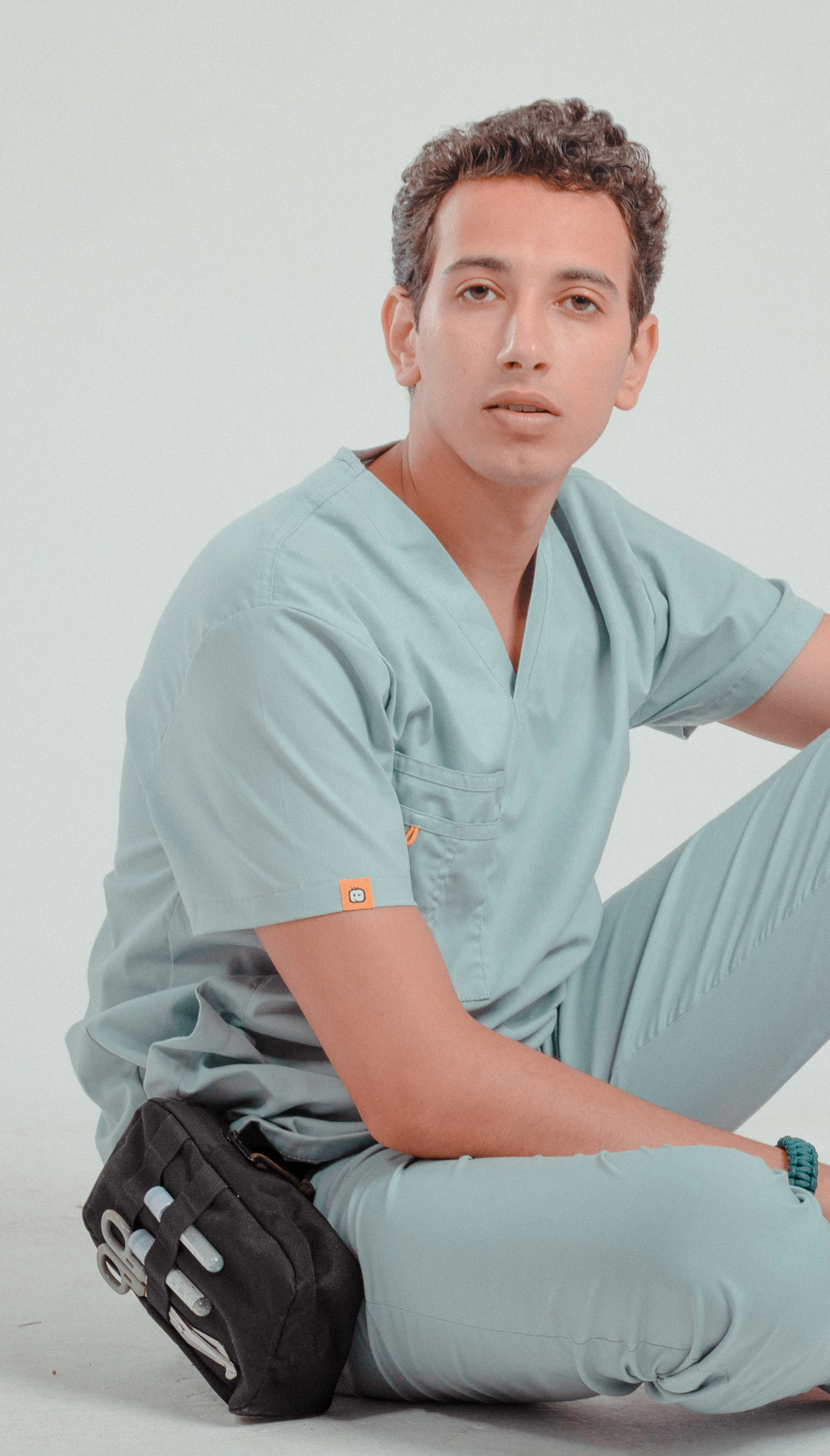 A student in clinical scrubs