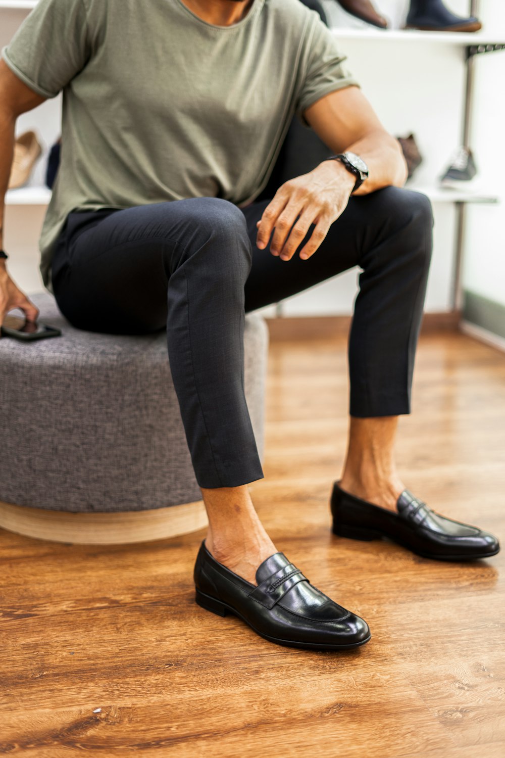 a man sitting on top of a round ottoman