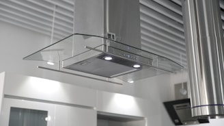 a kitchen hood mounted on the wall above a stove