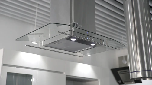 a kitchen hood mounted on the wall above a stove