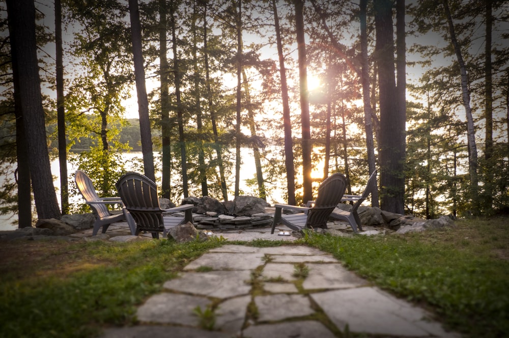 a couple of chairs sitting on top of a stone walkway