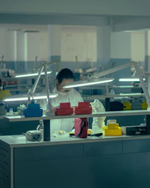 a woman working in a factory wearing a face mask