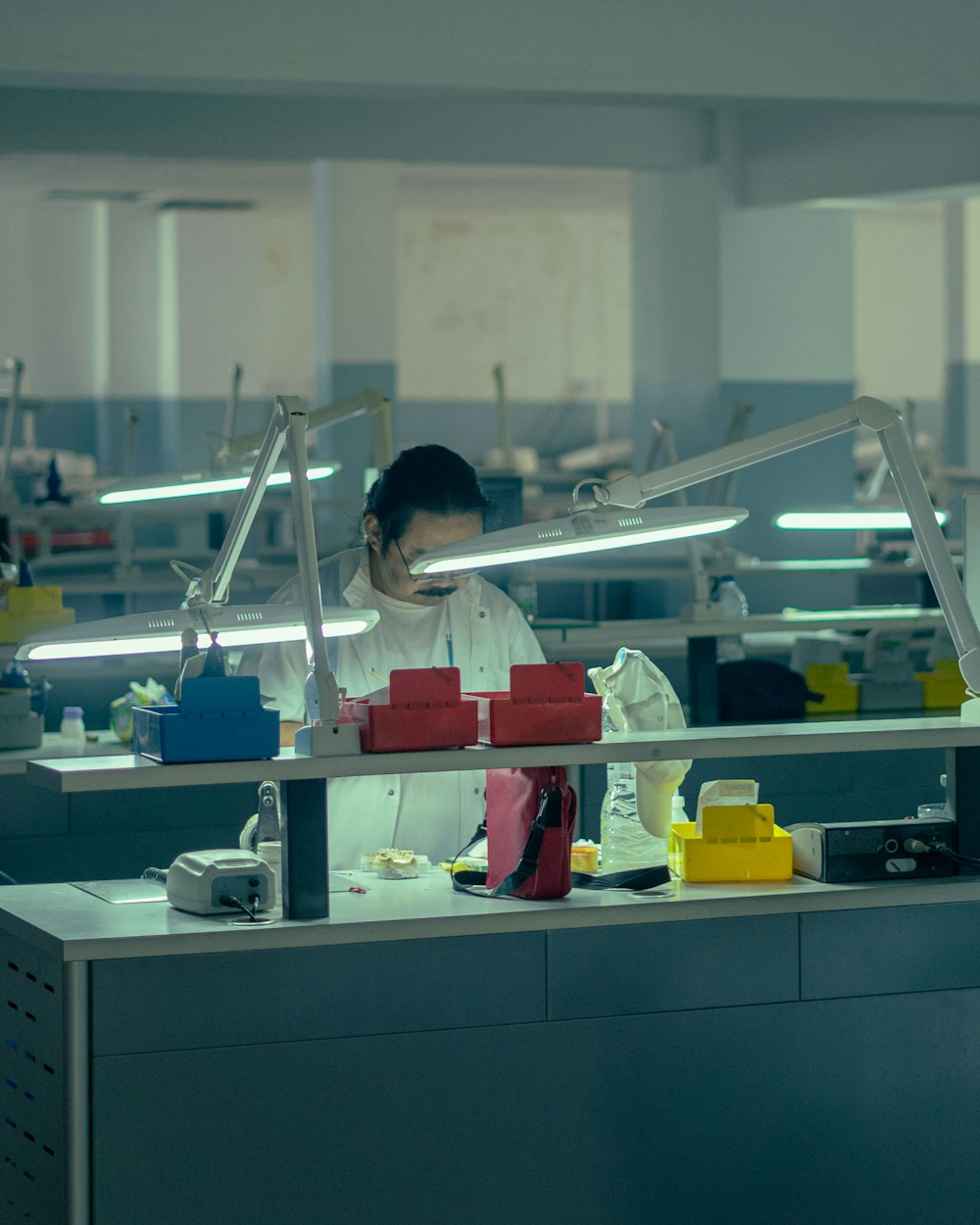 a woman working in a factory wearing a face mask