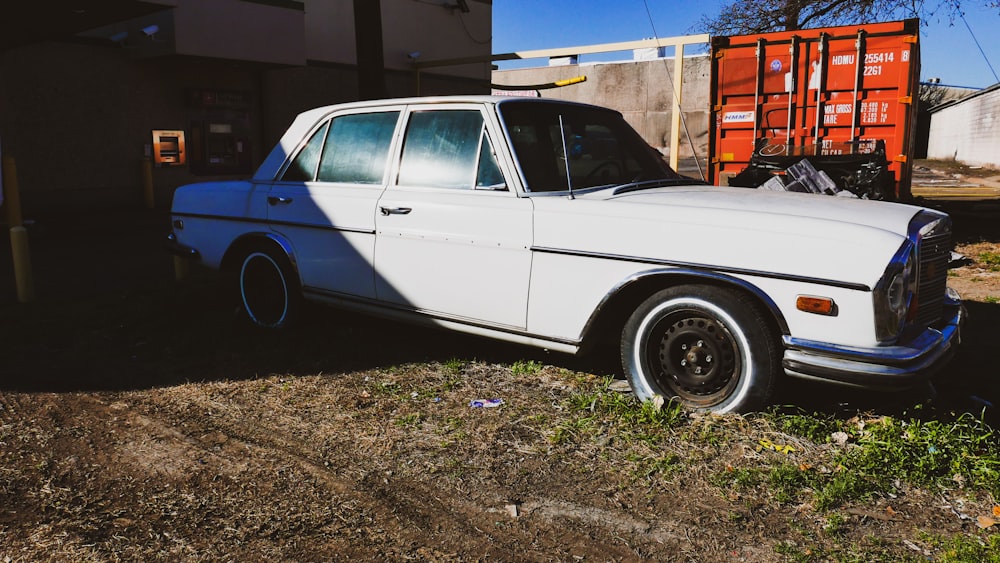 a white car parked next to a building