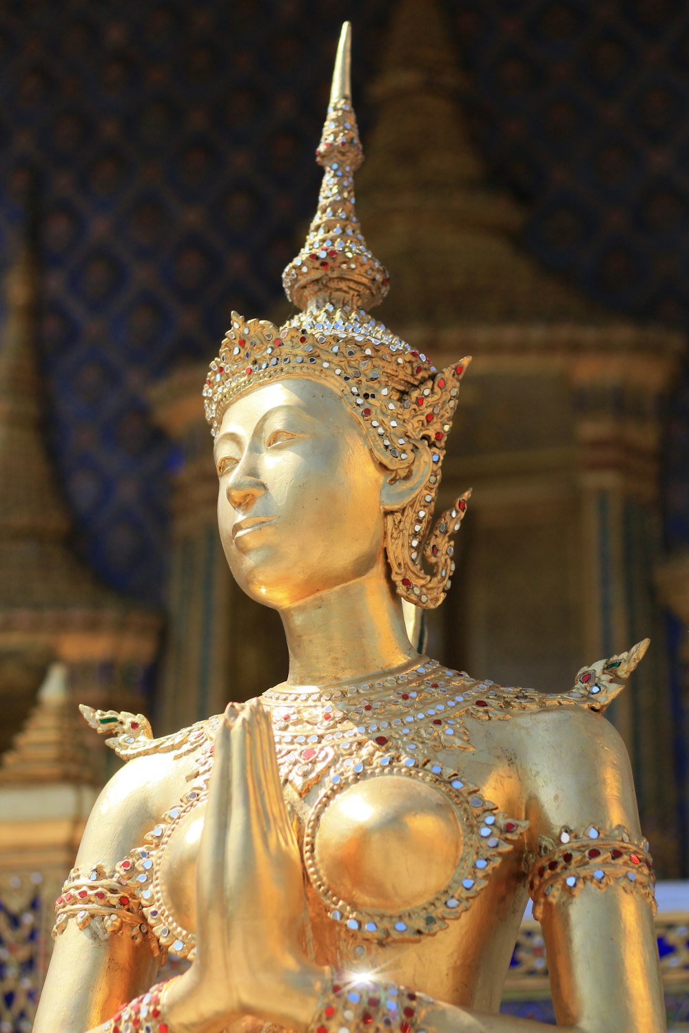 a golden statue of a woman with a crown on her head