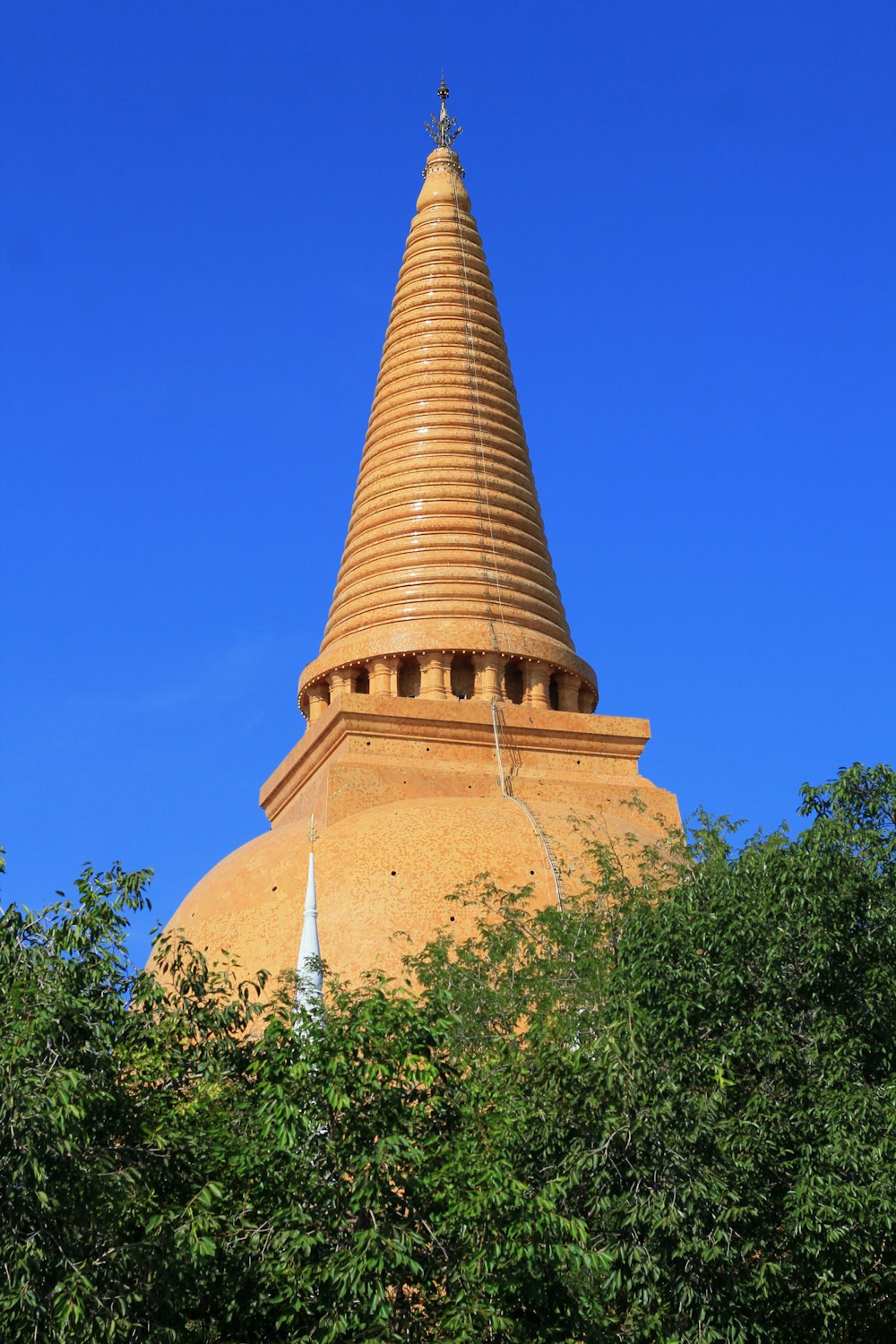 a very tall tower with a cross on top of it