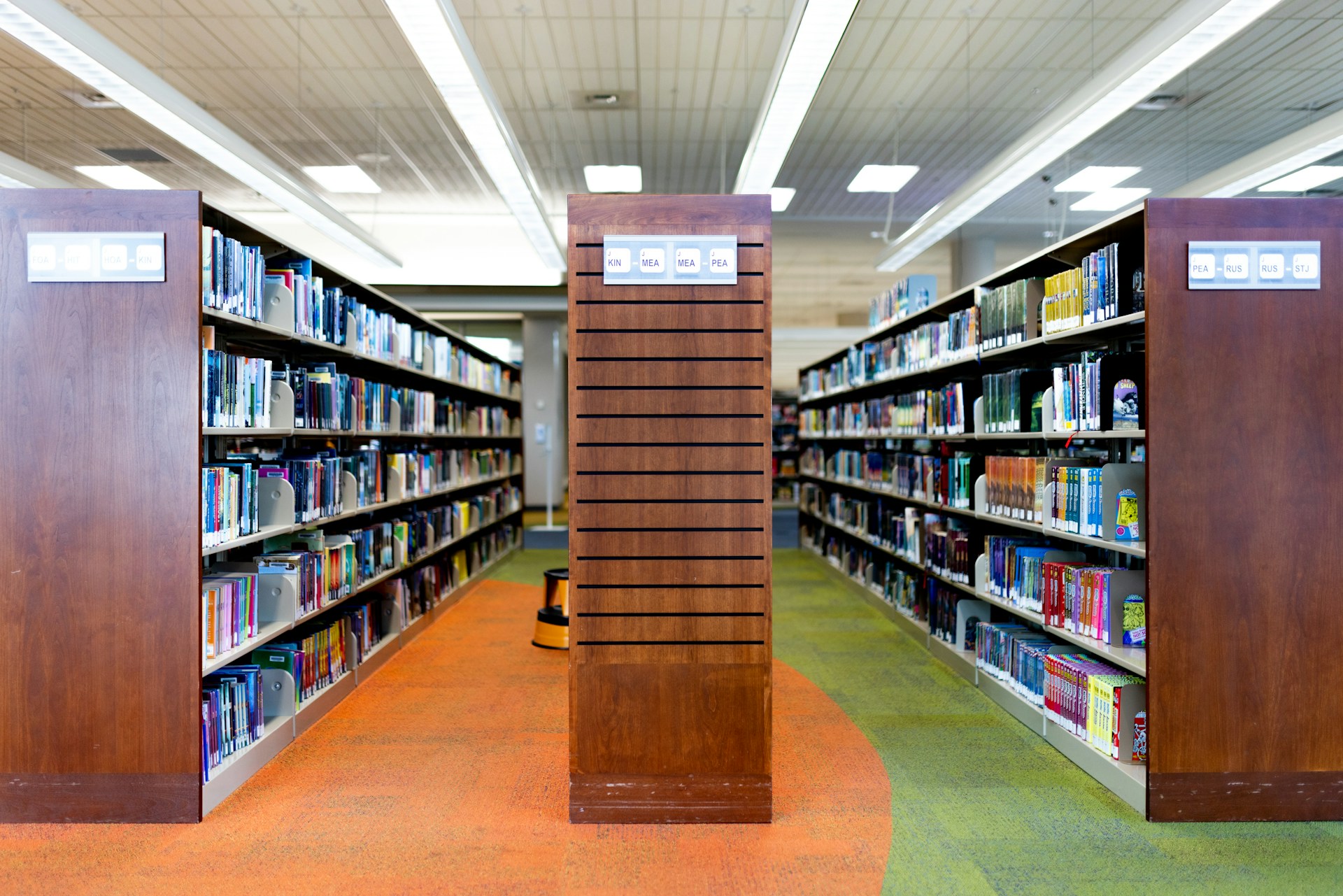 a row of bookshelves in a library filled with books
