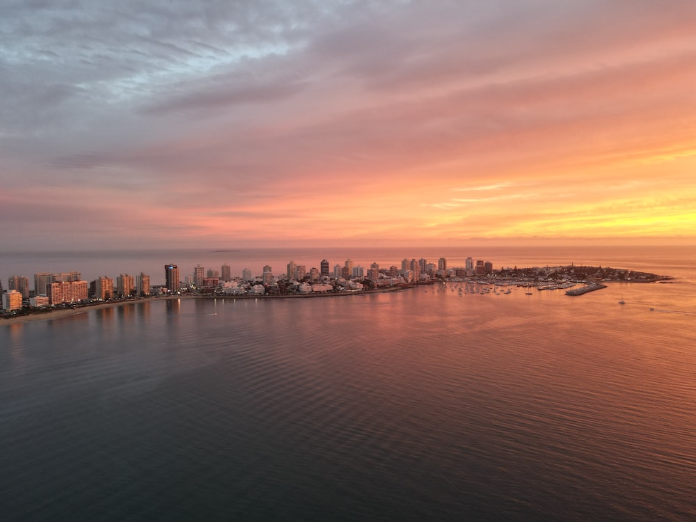 a large body of water with a city in the background