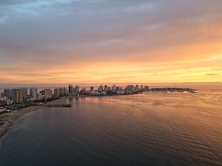 a large body of water with a city in the background