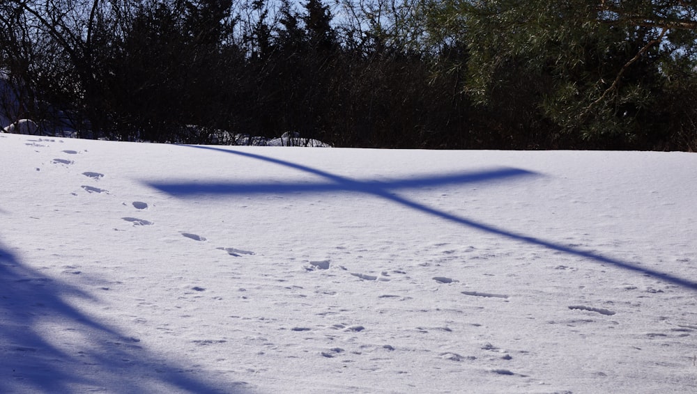 a person riding a snowboard down a snow covered slope