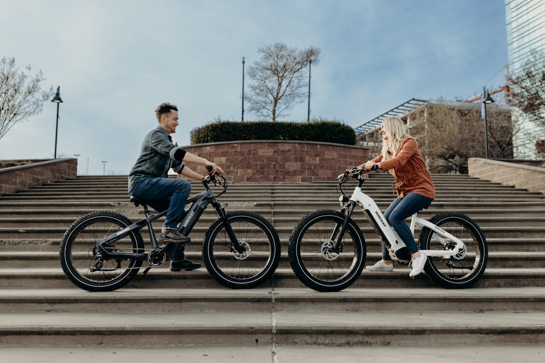 a man and a woman riding bikes down a flight of stairs