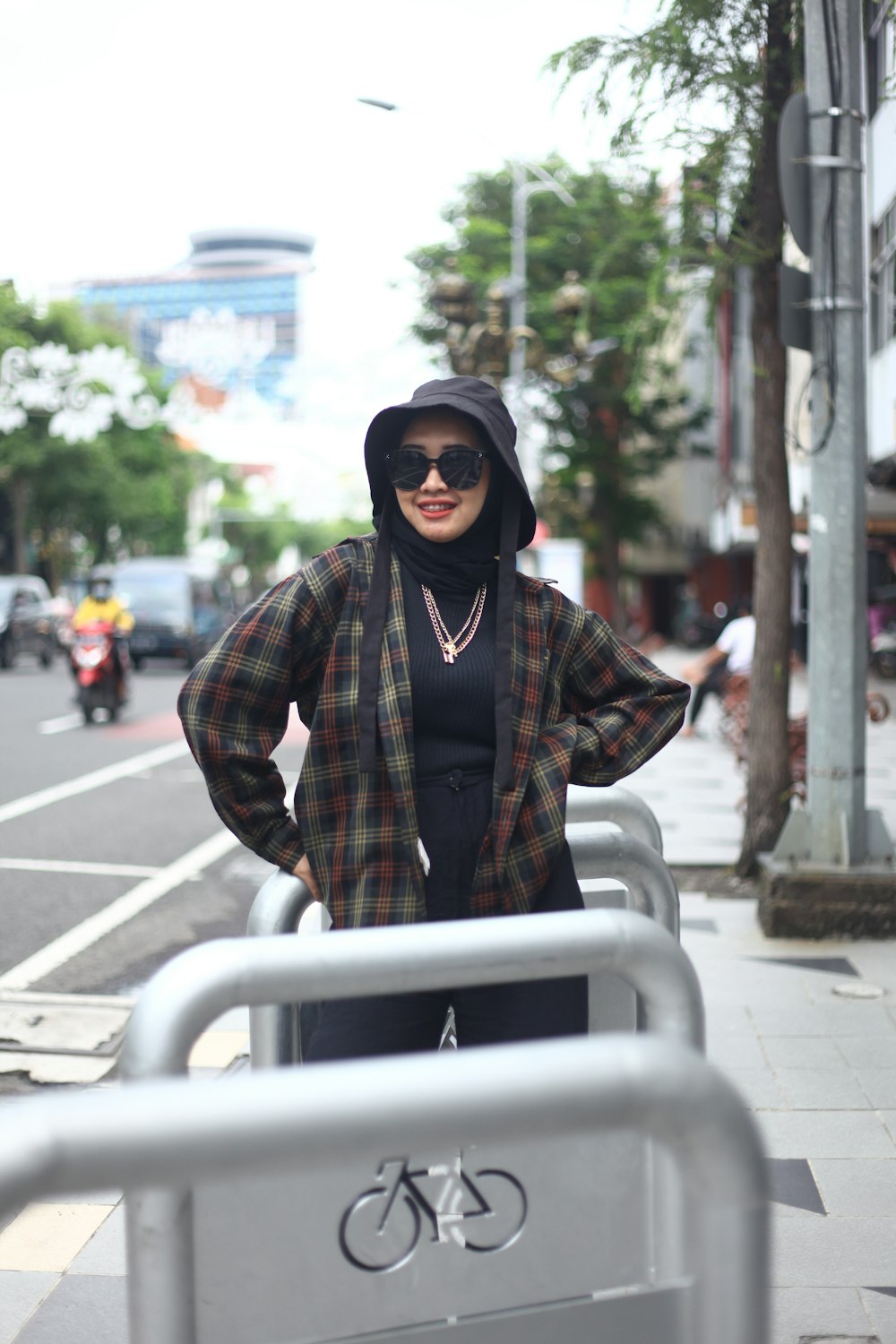 a woman standing next to a metal barricade