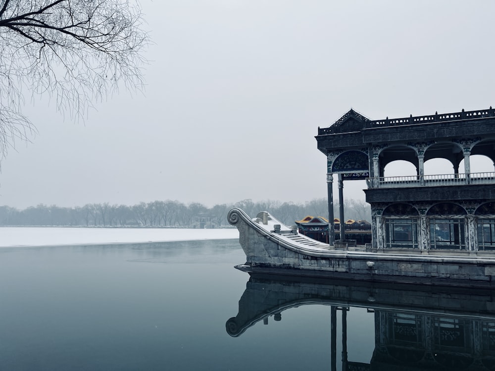 a boat is sitting in the water near a pavilion