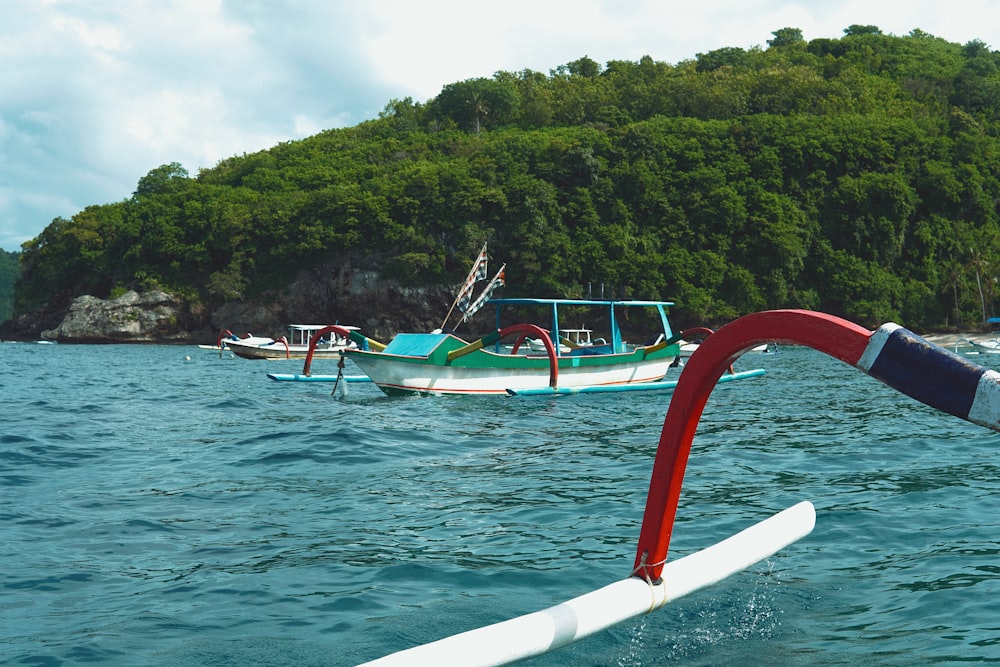 a couple of boats floating on top of a body of water