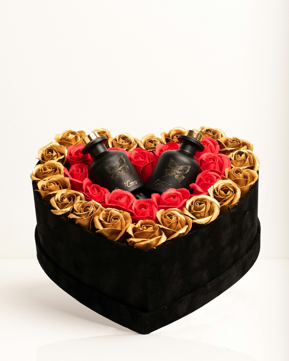 a heart shaped box filled with two black boots