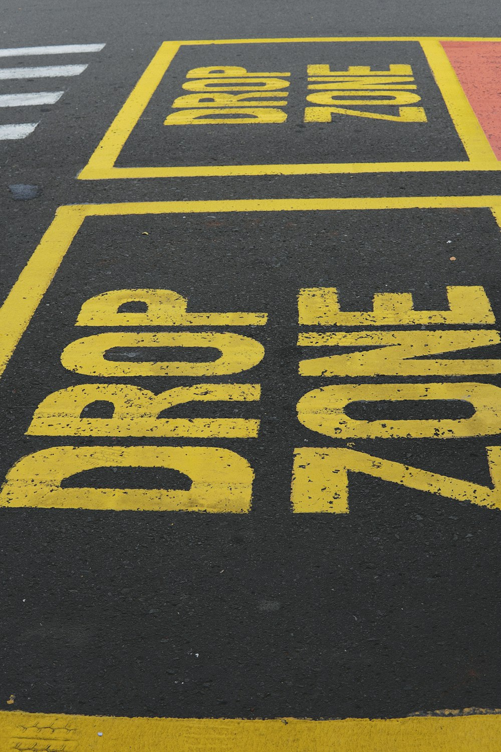 a bus stop sign painted on the side of the road