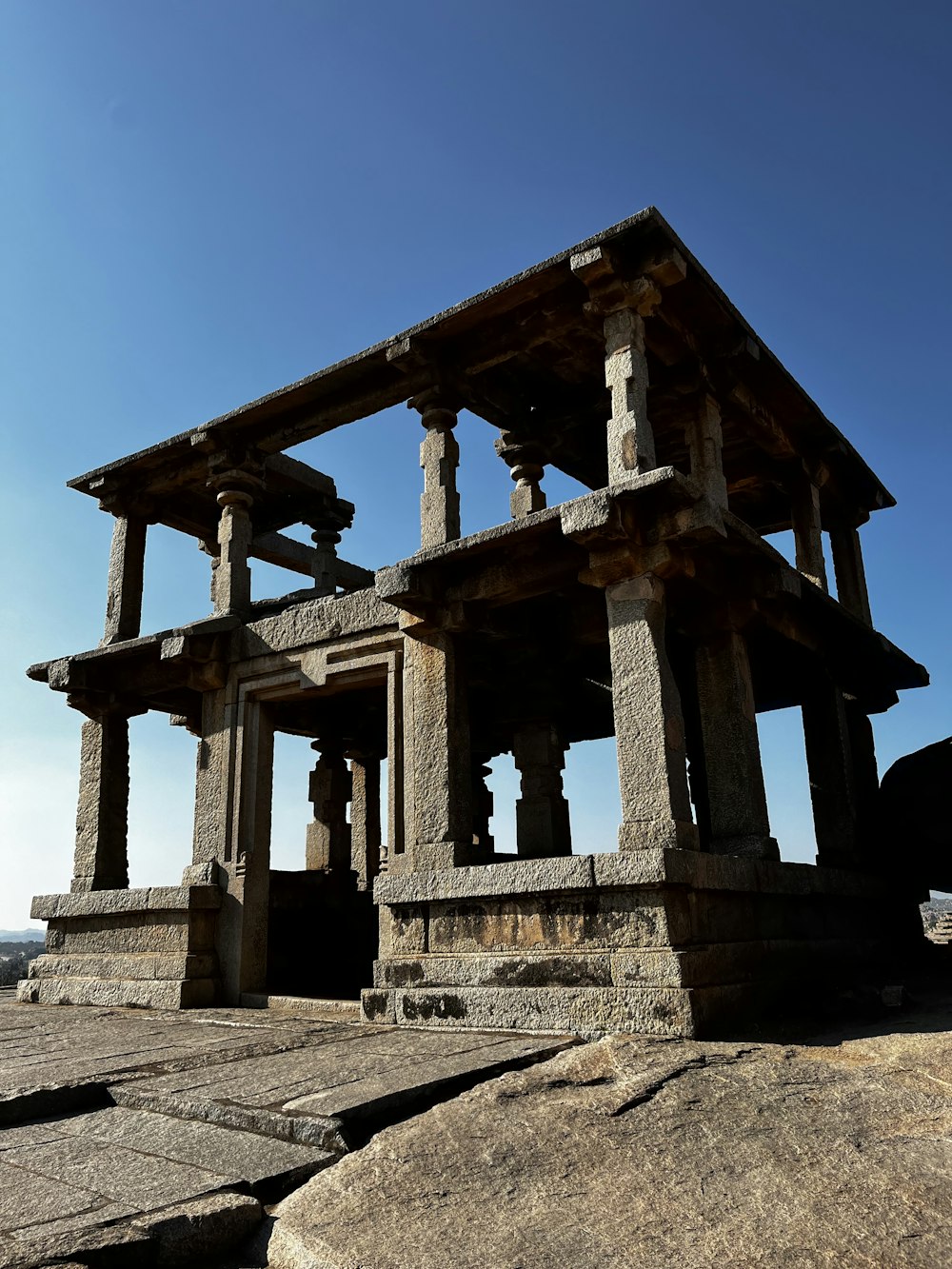 a stone structure sitting on top of a large rock