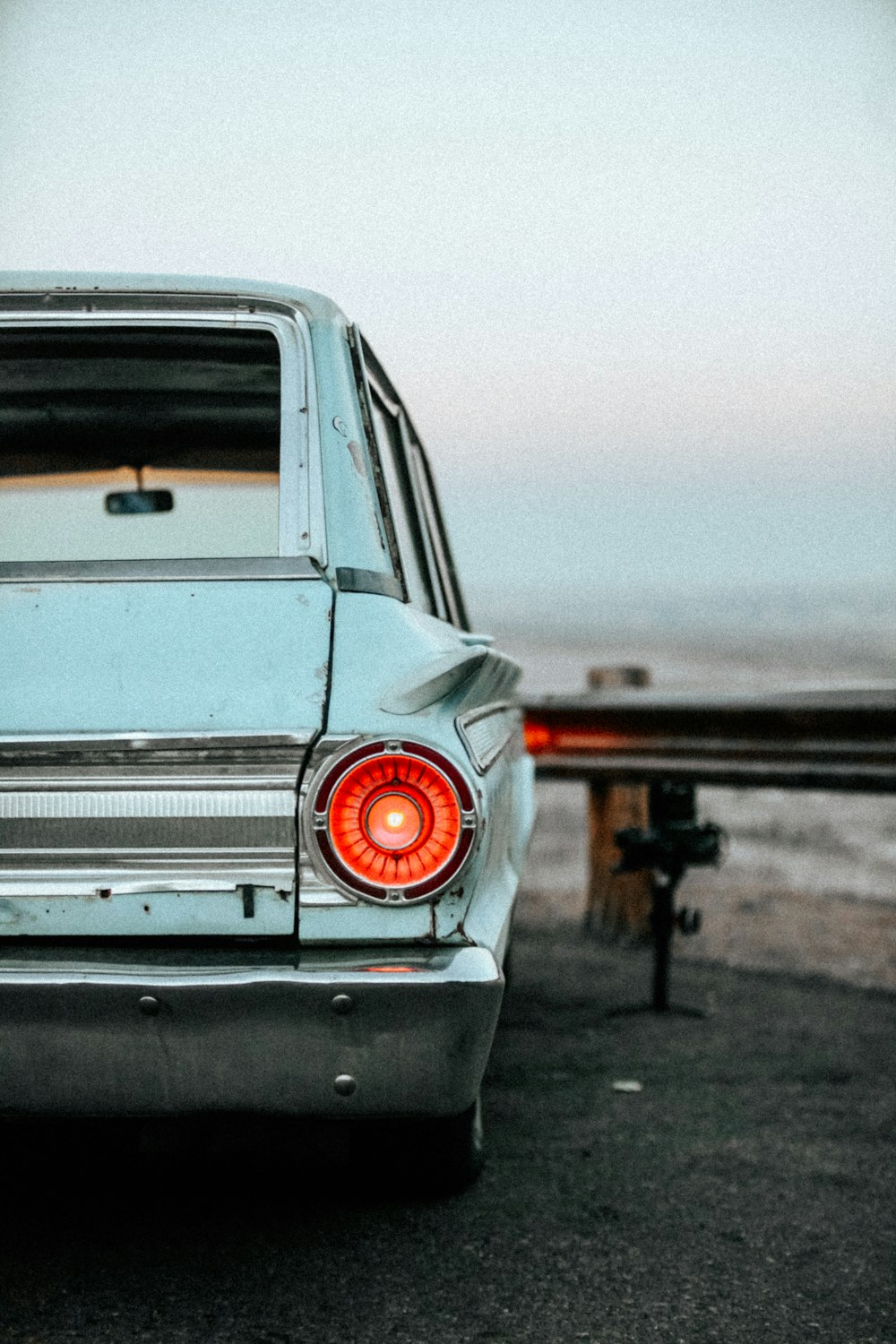 a car parked on the side of the road near the ocean