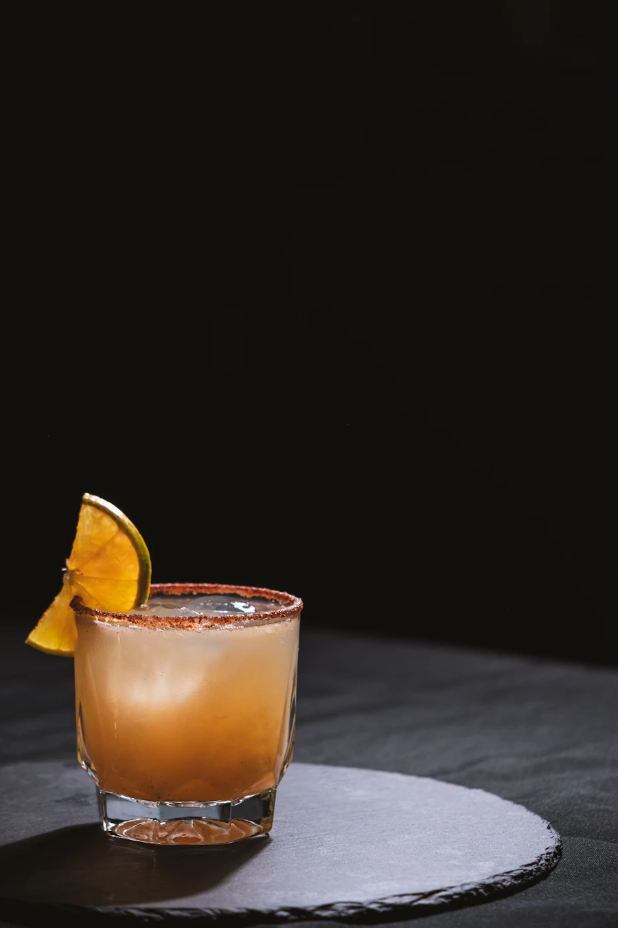 A glass of mezcal served on a plate