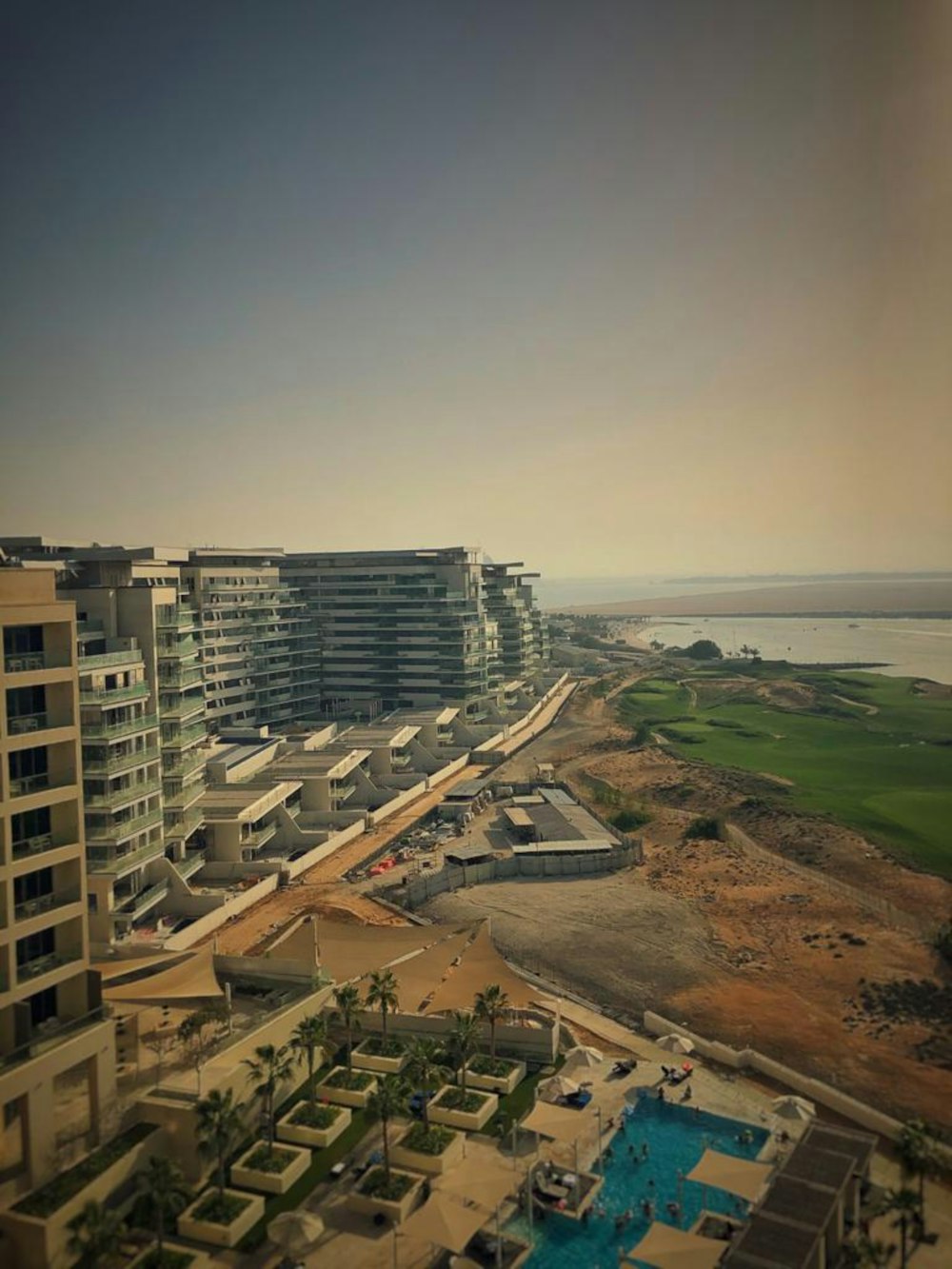 an aerial view of a beach resort and a golf course