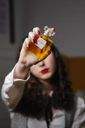 a woman holding a bottle of liquor up to her face