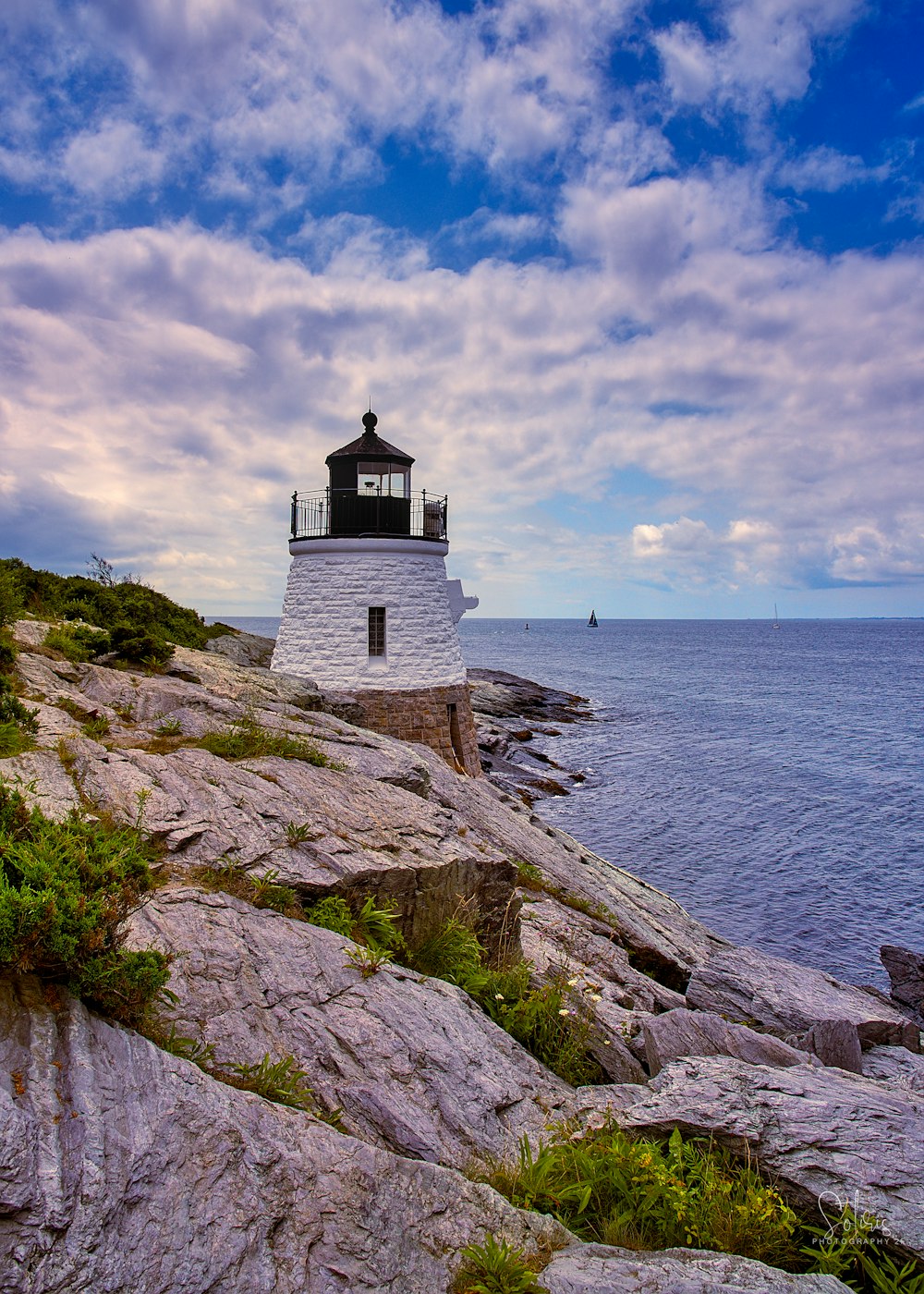 a light house sitting on top of a rocky cliff