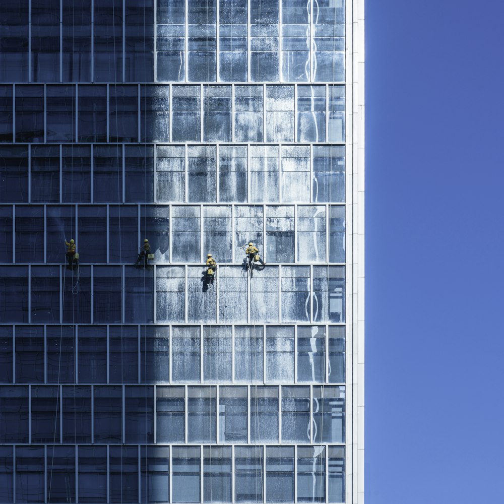 a tall glass building with a sky in the background