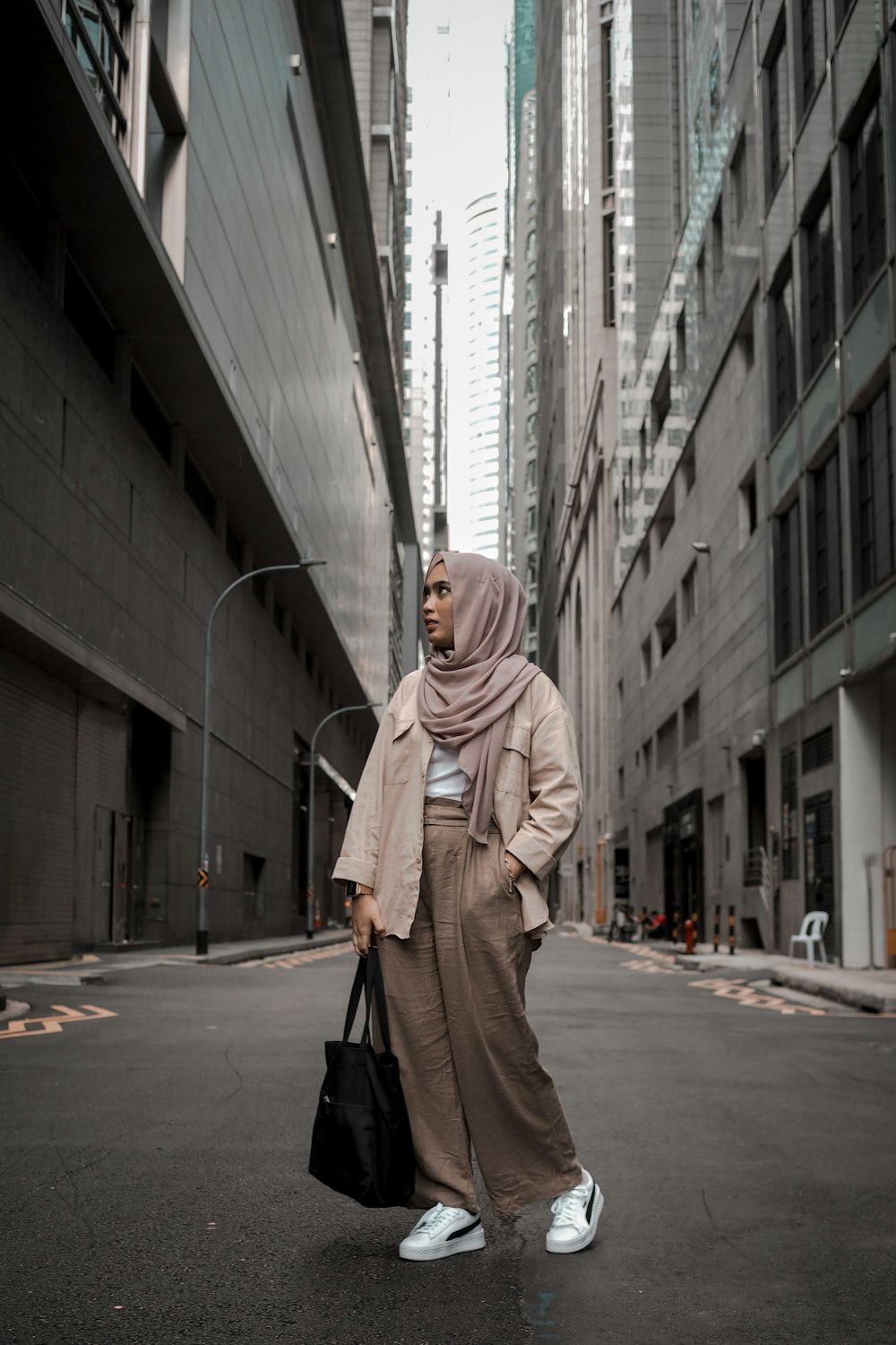 a woman in a hijab is walking down the street