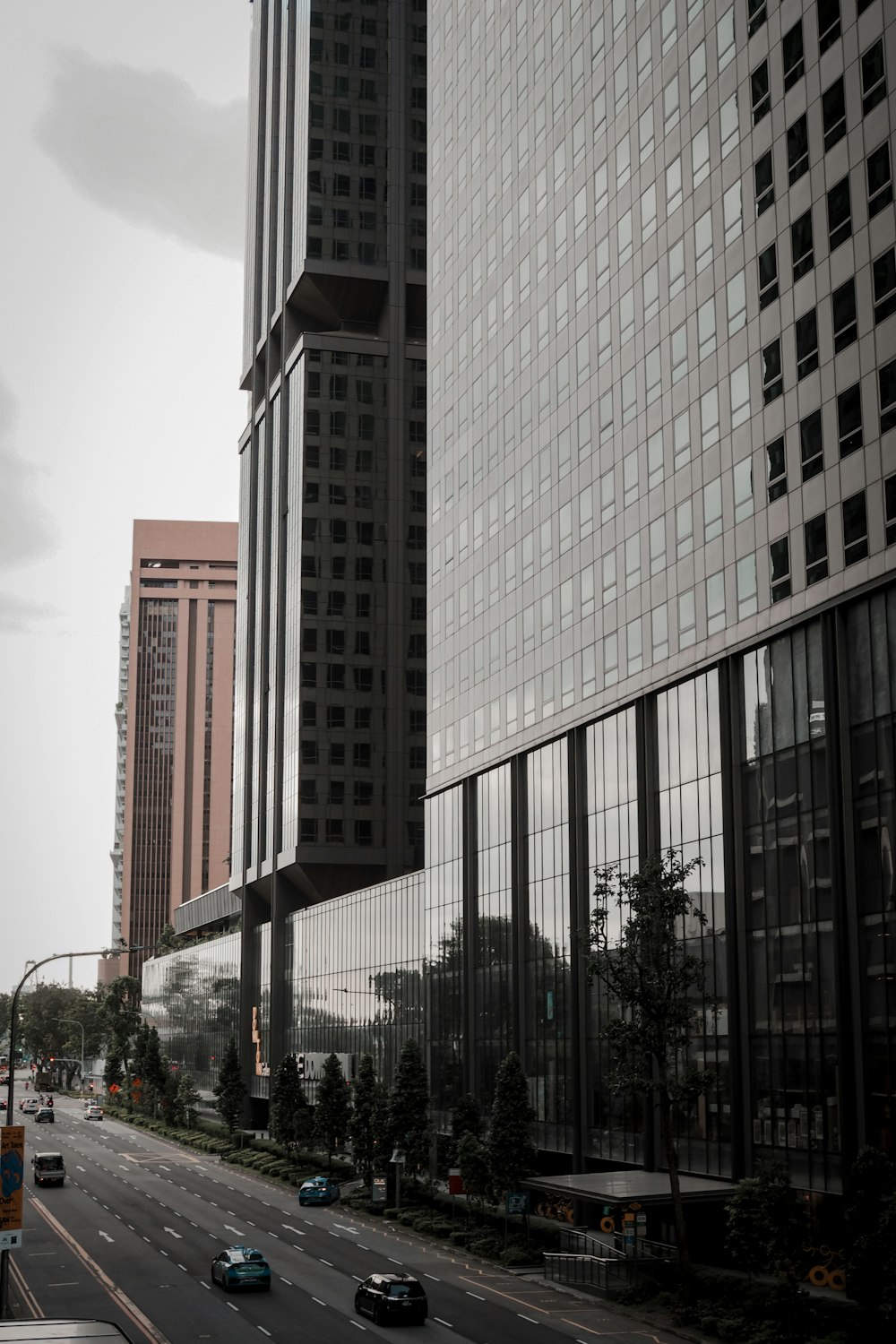 a city street filled with lots of traffic next to tall buildings