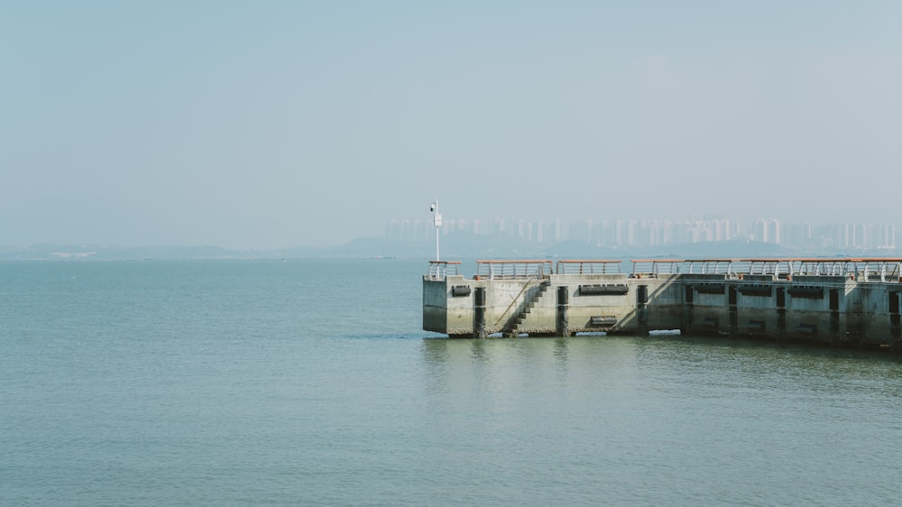 a large body of water next to a pier