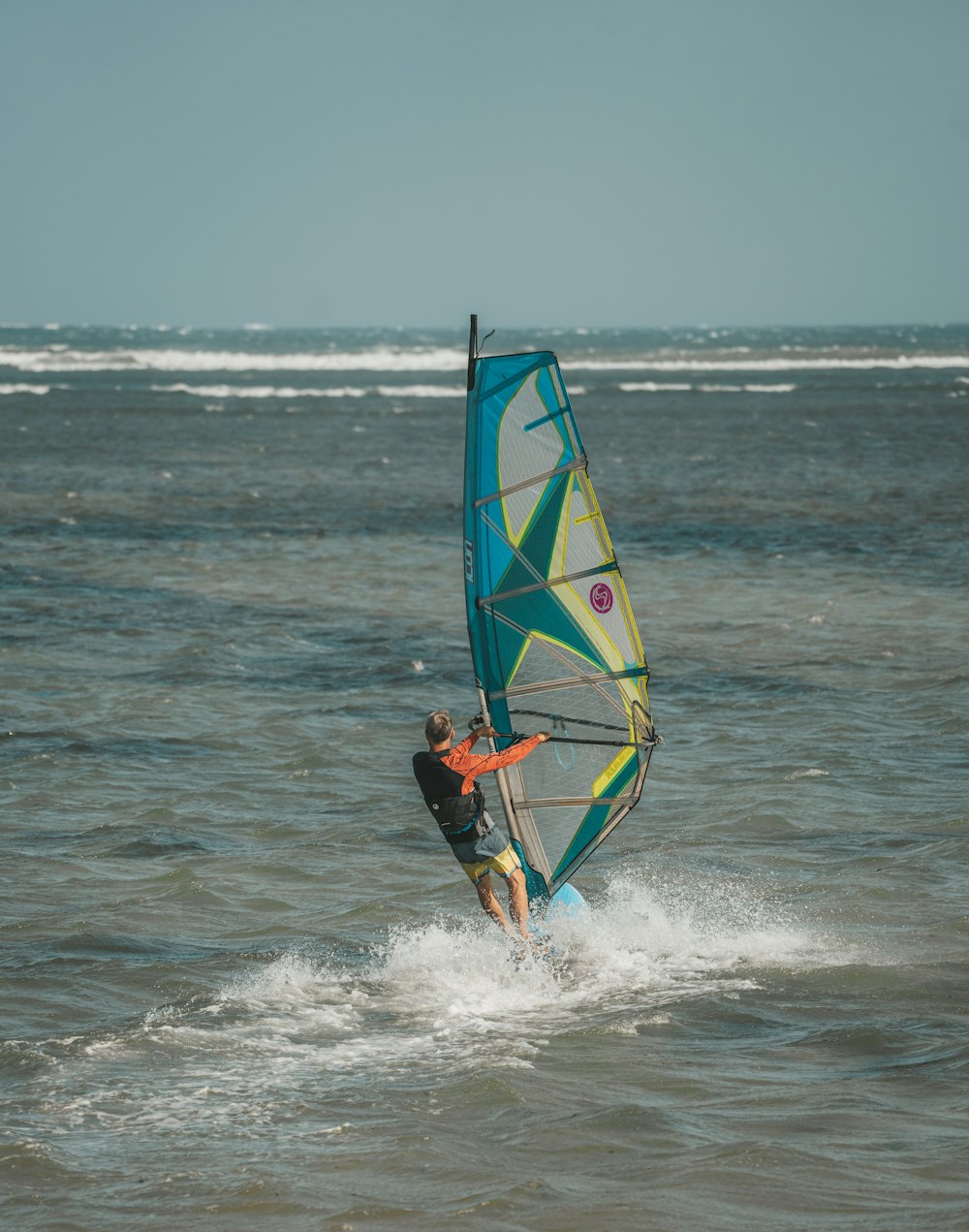 a man riding a wind sail on top of a body of water