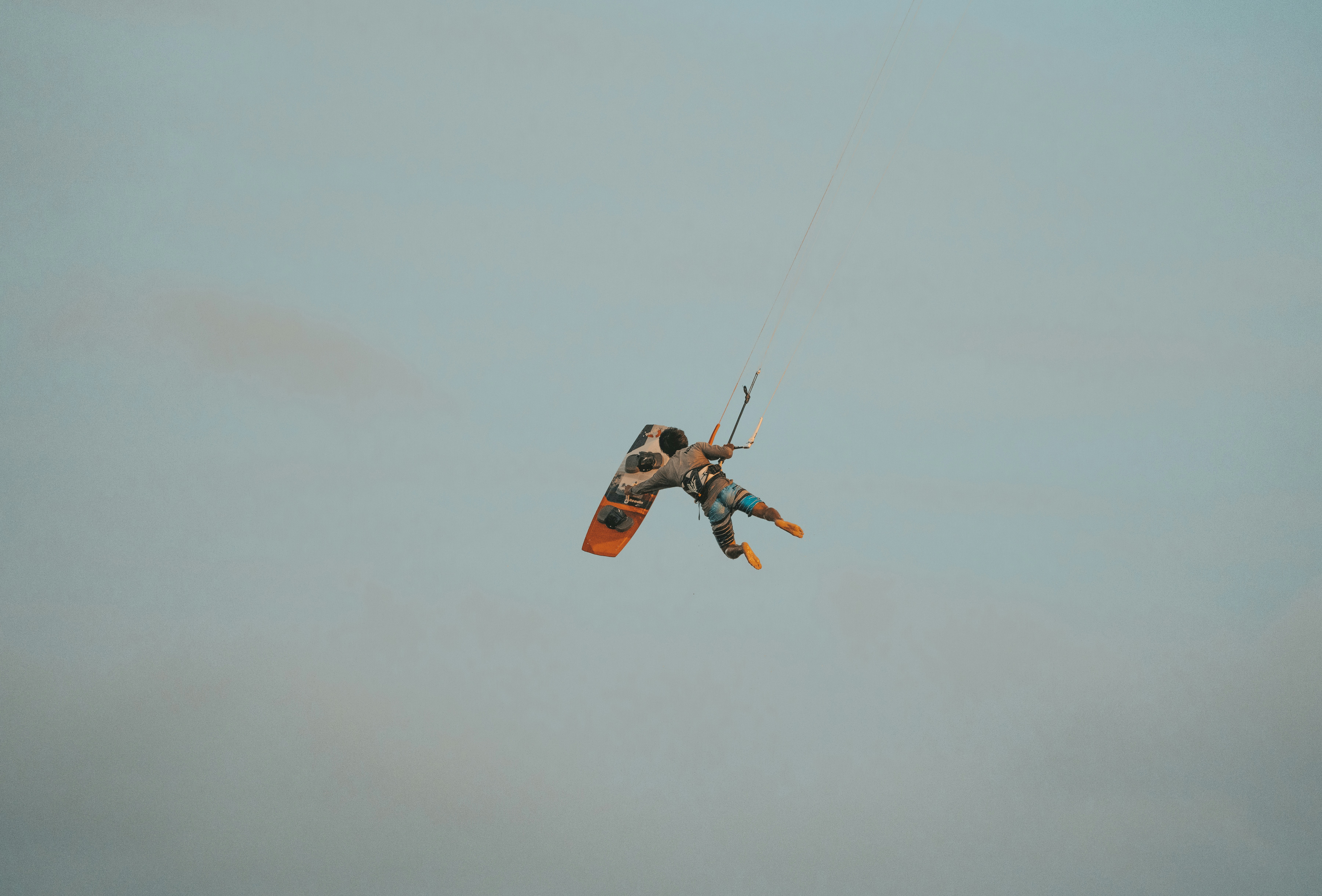 a person is parasailing in the air on a clear day