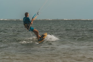 a man riding a board on top of a body of water