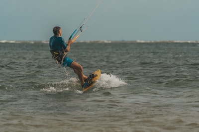 a man riding a board on top of a body of water