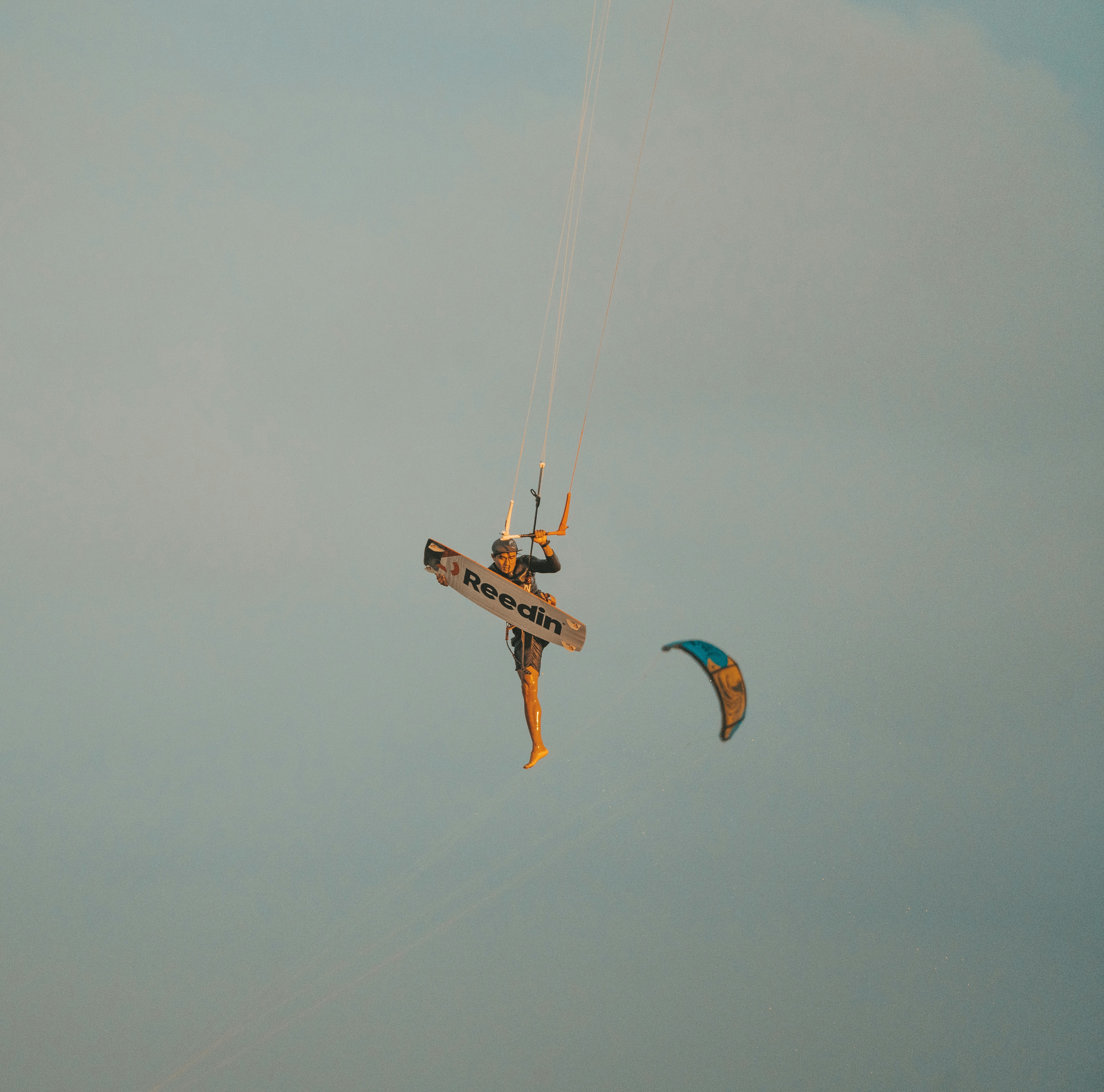 two people are parasailing in the ocean on a cloudy day