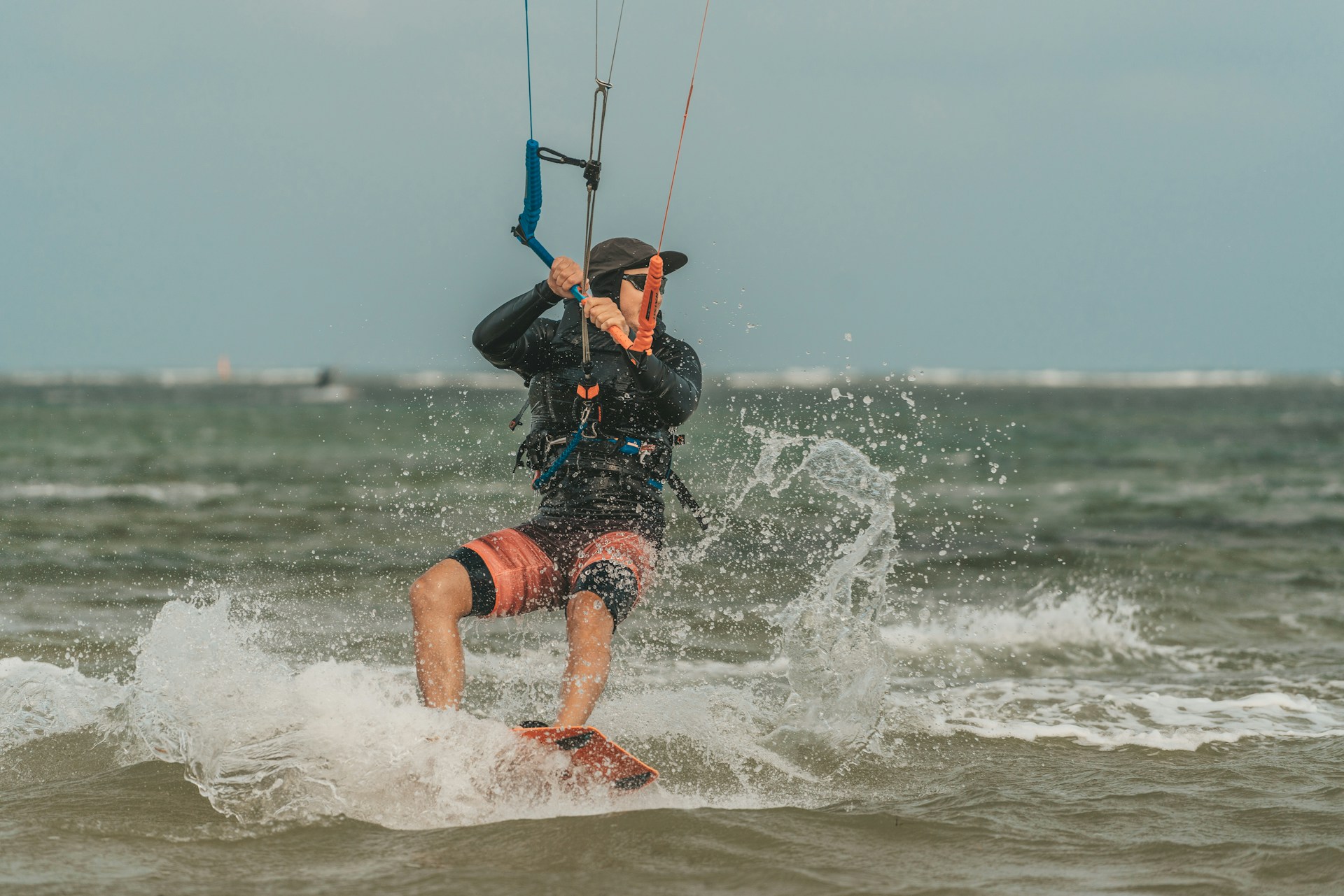 a man riding a kite board on top of a wave