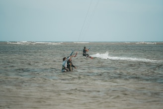 a group of people riding water skis on top of a body of water