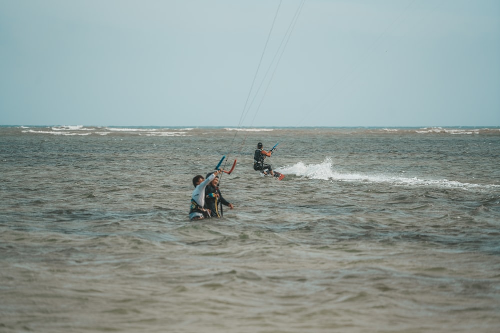 a group of people riding water skis on top of a body of water