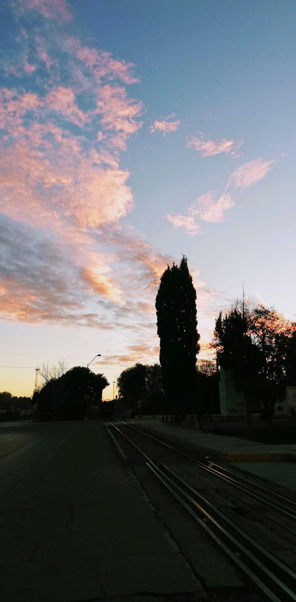 the sky is pink and blue as the sun sets