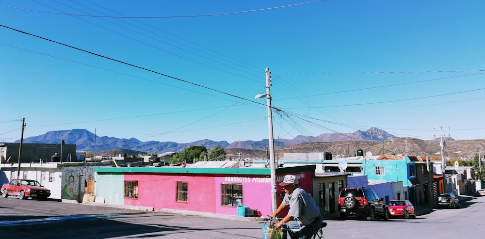 a person riding a bike down a street