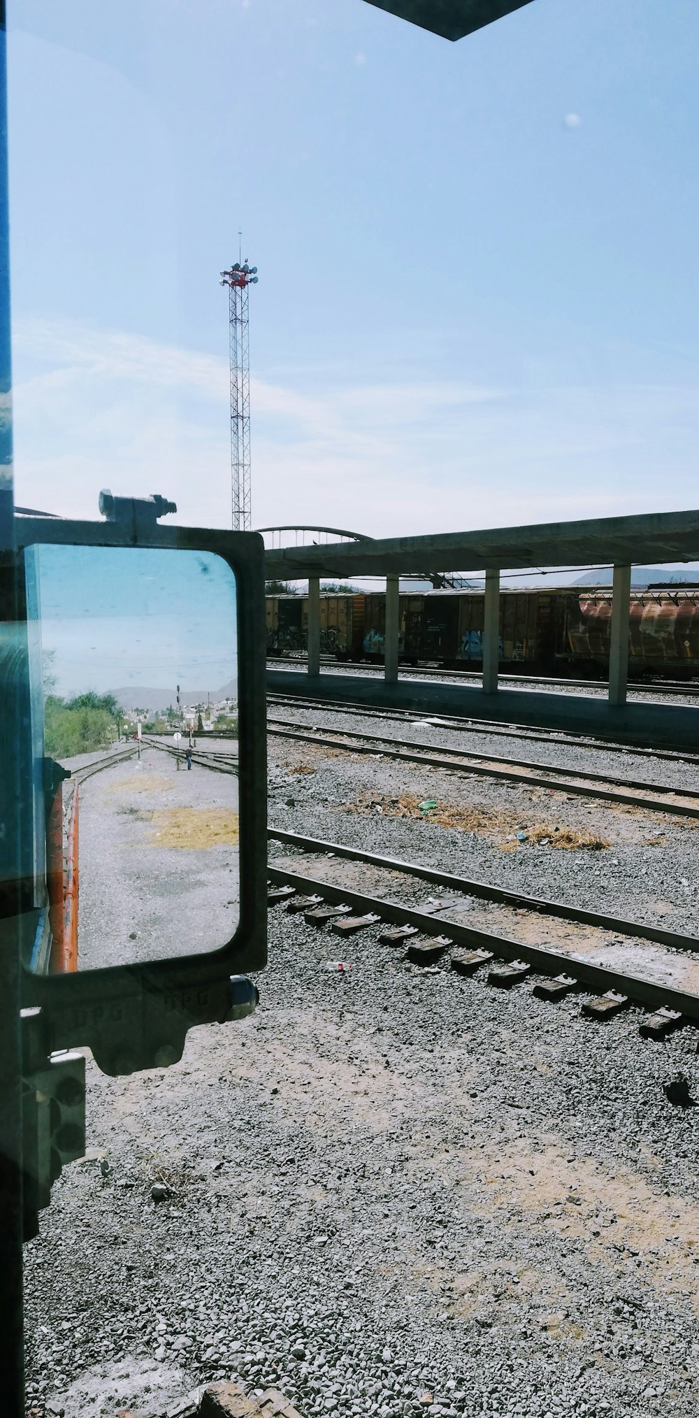 a mirror on the side of a train track