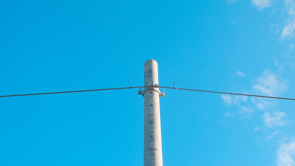 an airplane is flying over a power line